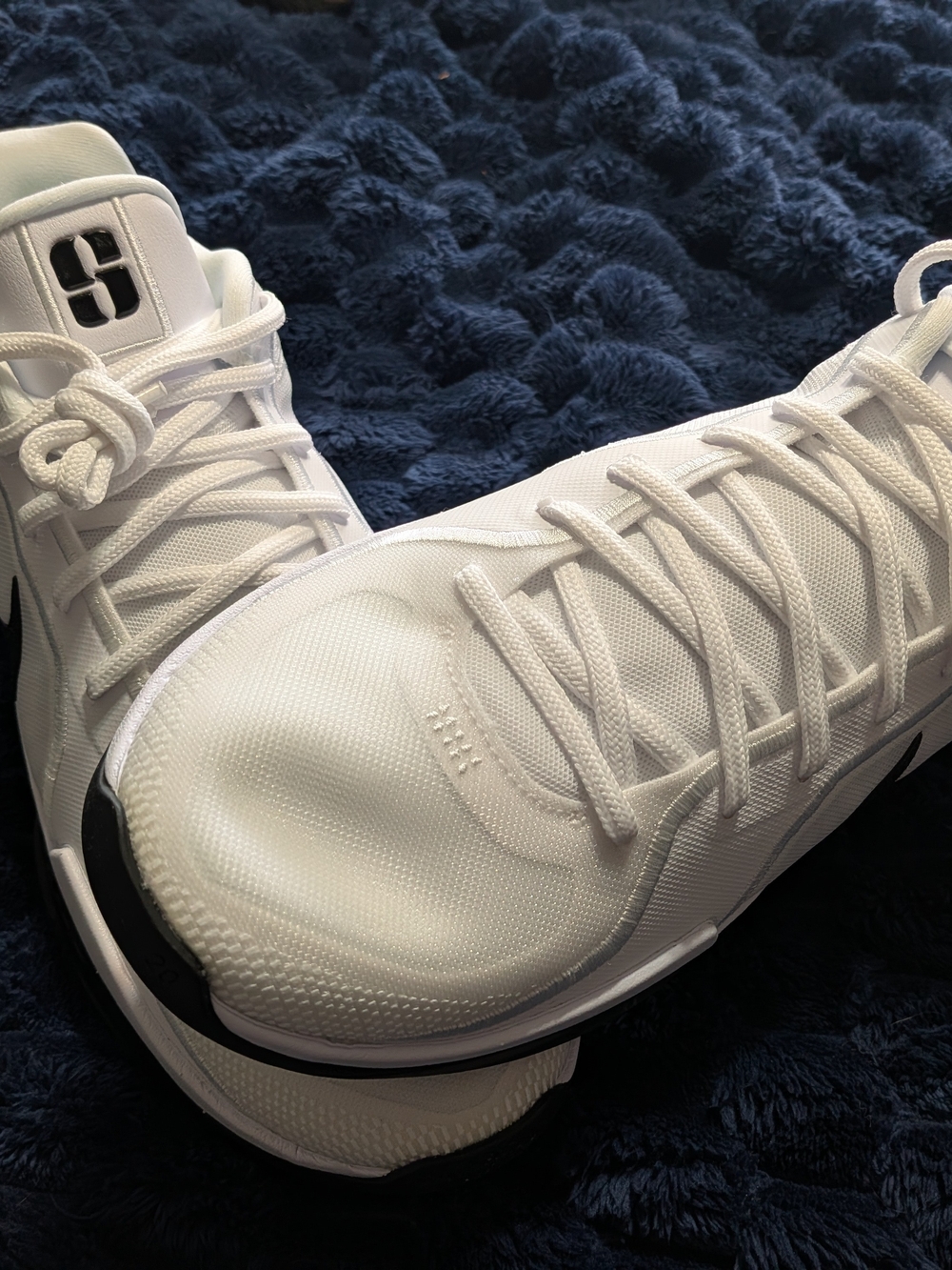 Nike White Athletic Shoes with Black Swoosh Accents